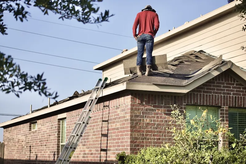 Professional roofer working on a residential roof in Florida Gulf Coast University